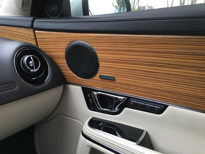 This particular car has the rare Satin Zebrano wood trim option, brightening the interior vibe substantially. The standard trim is dark burl walnut, but either way, the XJ’s enormous slabs of wood trim really set it apart from competitors. Another clue to the 2014 updates: D-shaped door pulls and electronic door lock buttons replace the old L-handle and mechanical lock tab.